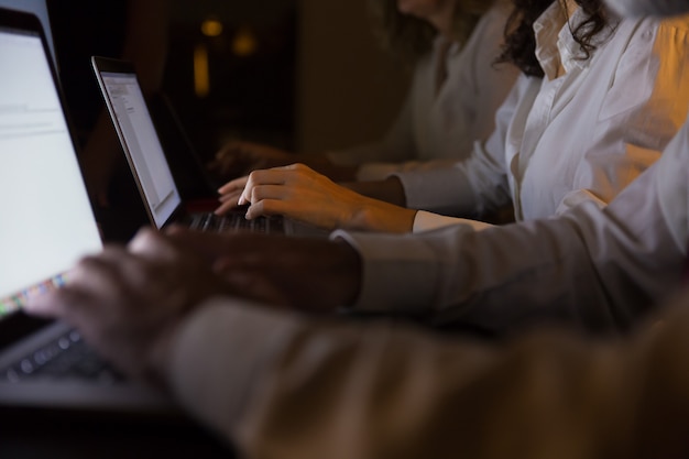 Free Photo cropped shot of business people working with laptops