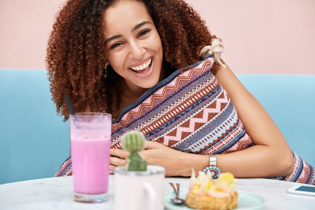 Cropped shot of joyful African American female being happy, meets with friend