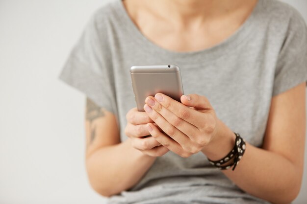 Cropped shot view of female hands holding cell phone