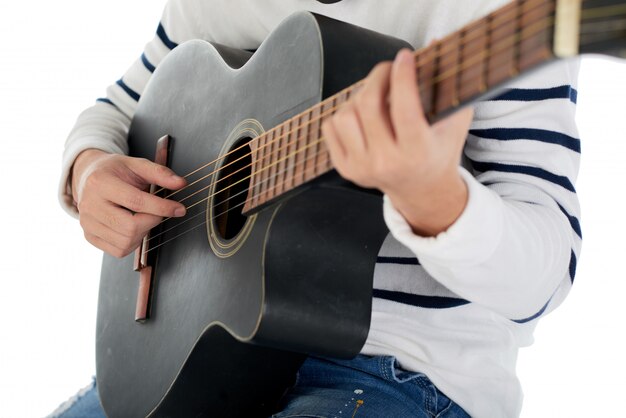 Cropped unrecognizable man playing the acoustic guitar