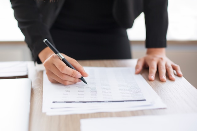 Free photo cropped view of businesswoman looking through list