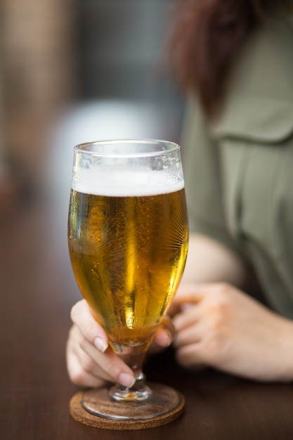 Cropped View of Woman Holding Glass of Beer