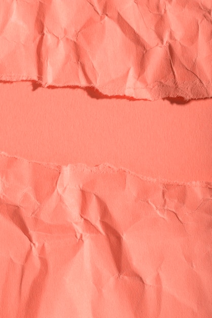 Crumpled paper texture on coral background