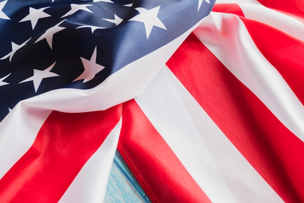 Crumpled USA flag on blue timber surface