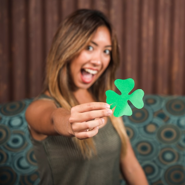 Free photo crying happy woman holding green paper clover