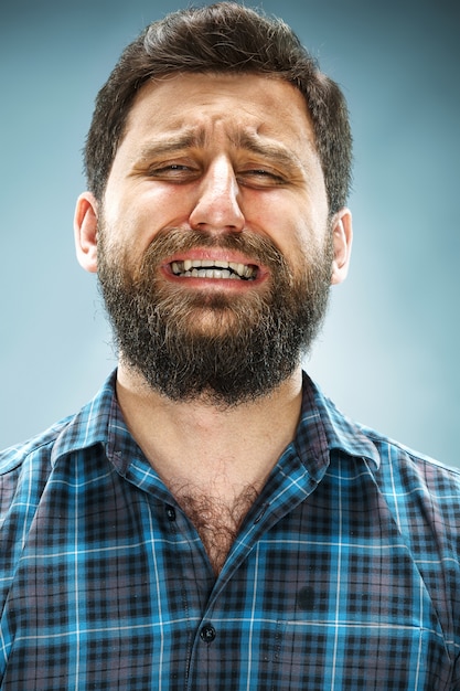 Free photo crying man in blue shirt