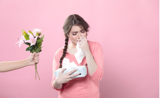 Free Photo crying woman is offered bouquet of lilies