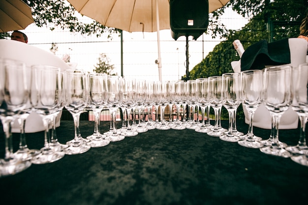 Free Photo crystal champagne flutes stand on a table 