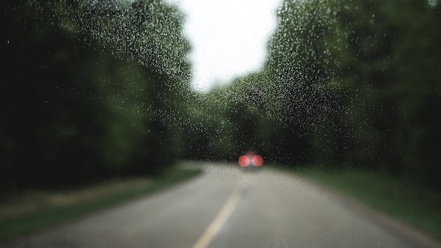 Crystal window with a blurred view of a car in a road