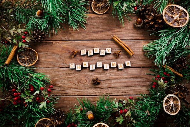 Free photo cubes with letters near christmas twigs