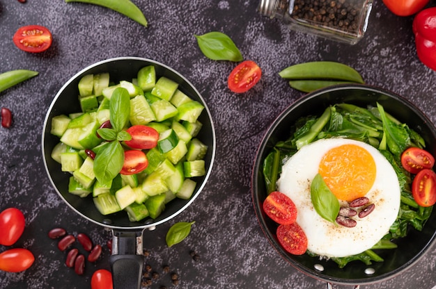 Free photo cucumber stir-fried with tomatoes and red beans in a frying pan.