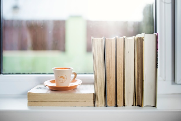 Cup and books on window sill