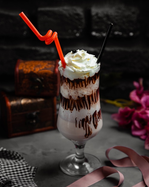 Cup of cappuccino milkshake with whipped cream and chocolate