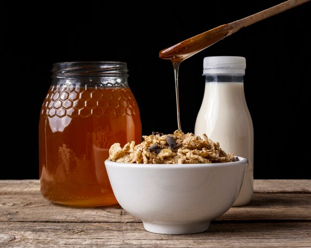 Cup of cereal with honey and milk