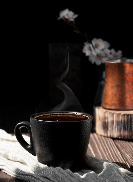 Free photo cup of coffee of aromatic espresso on a wooden surface