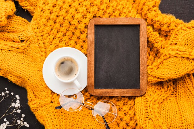 Cup of coffee beside frame