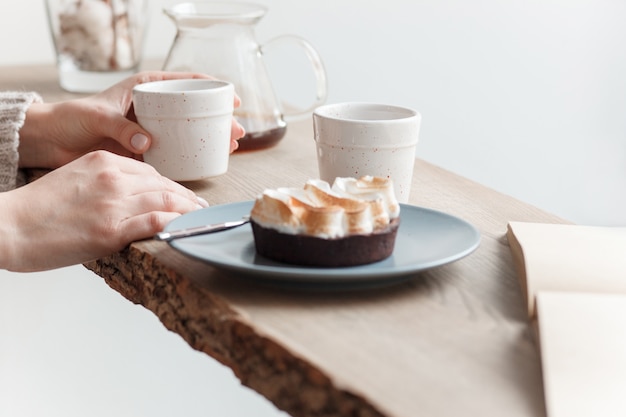 Cup of coffee, branch of tree, wooden windowsill