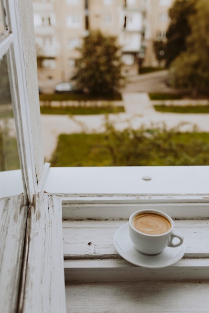 Free Photo a cup of coffee by the window