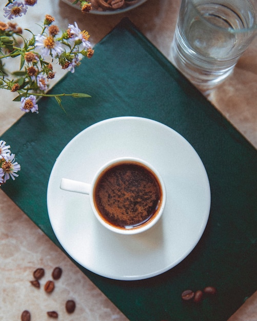 Cup of coffee and coffee beans on the table