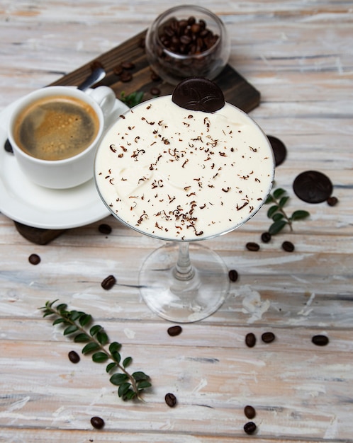 A cup of coffee, espresso with milky shake, vanilla cream cocktail, decorated with chocolate chips. 