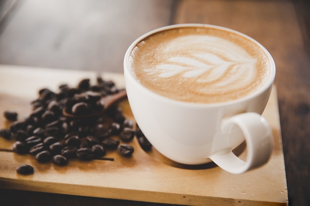 Cup of coffee latte on wood table in coffee shop cafe 