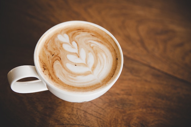 Free photo cup of coffee latte on wood table in coffee shop cafe