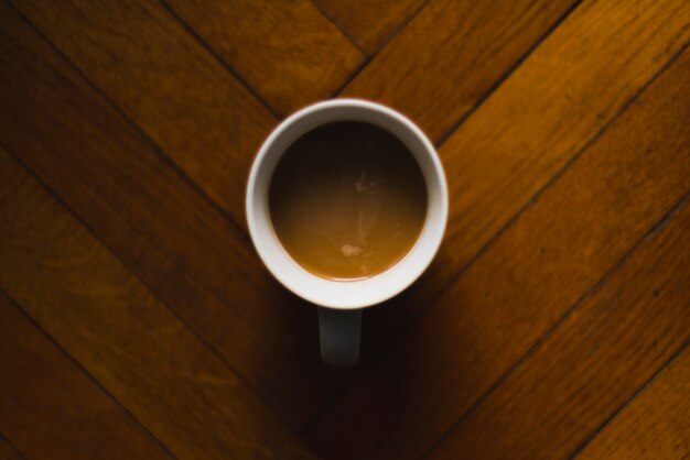 Cup of coffee on parquet