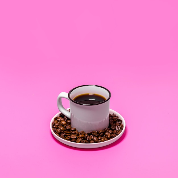 Free photo cup of coffee on pink background