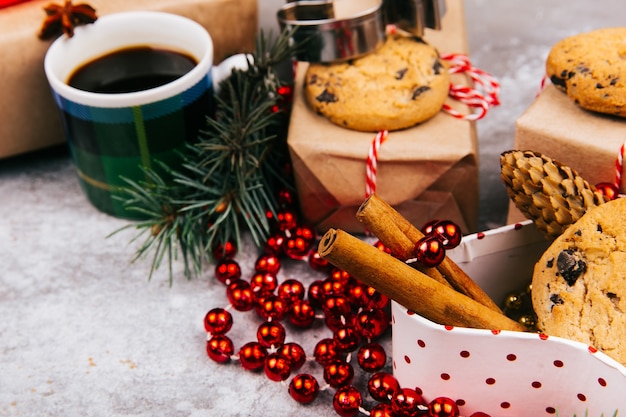 Cup of coffee stands in the circle made of different kinds of Christmas decor