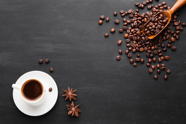 Free photo cup of coffee with beans and anise