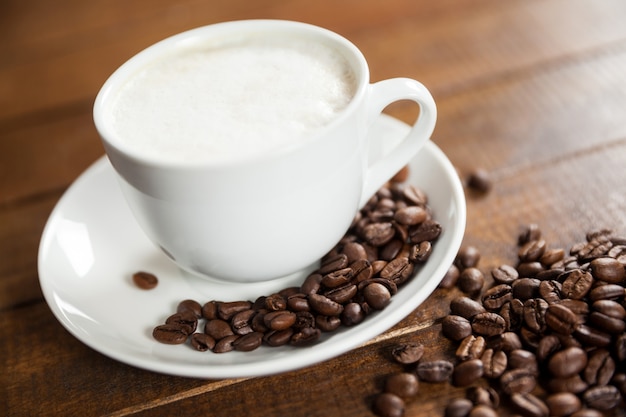 Cup of coffee with coffee beans and spoon