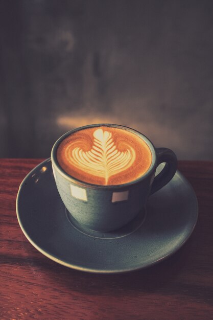 Cup of coffee with a drawing in the foam