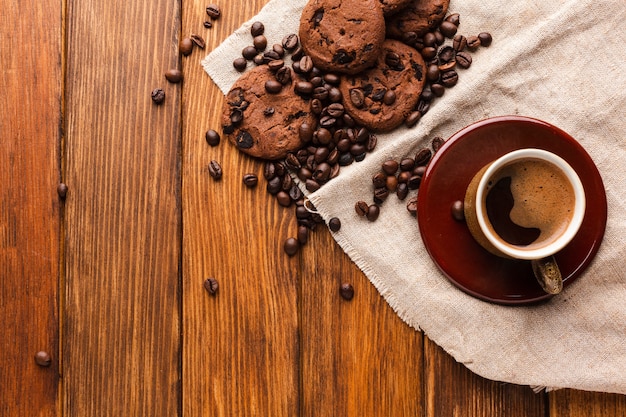 Cup of coffee with tasty cookies