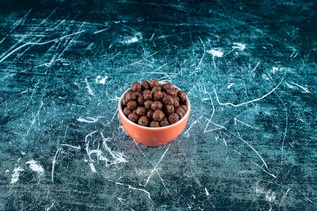 A cup of corn balls , on the blue background. High quality photo