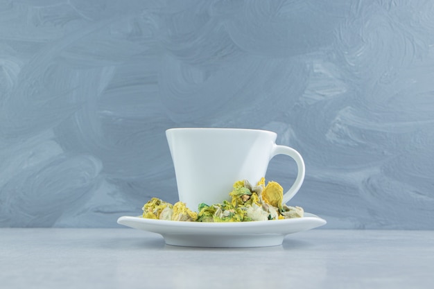 Free Photo cup of herbal tea with yellow flowers. 