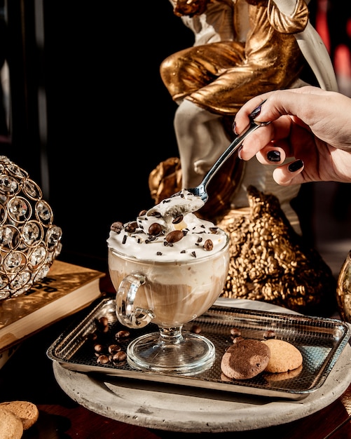 Free Photo cup of latte with cream garnished with chocolate pieces and coffee