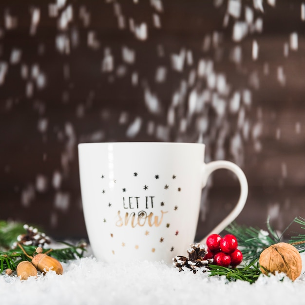 Cup near snags and branches on snow