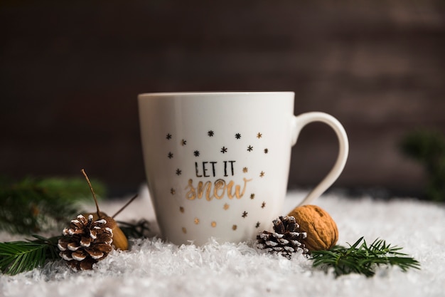 Cup near snags, nuts and twigs on snow