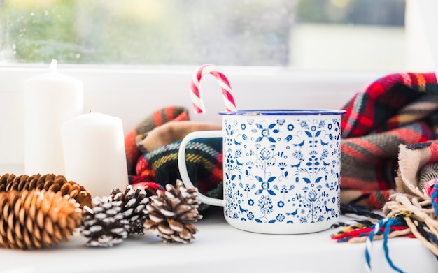 Cup near snags and scarf on window sill