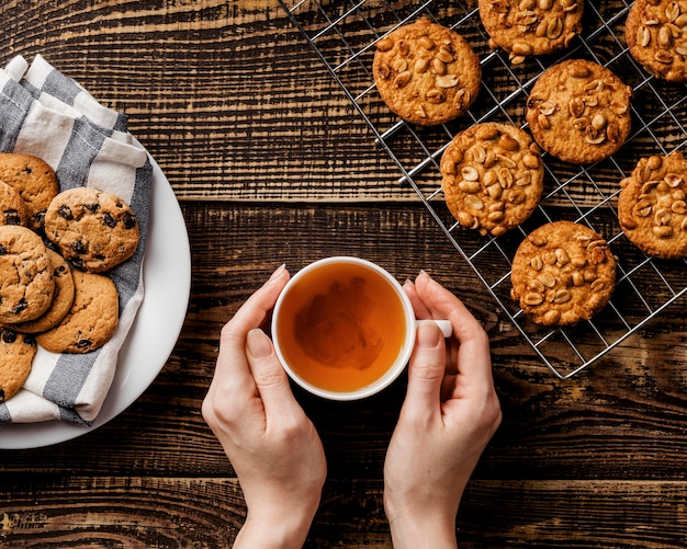 cup of tea and Delicious cookies on table