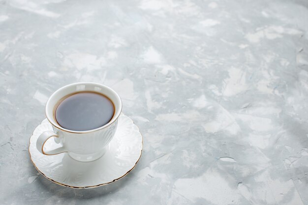 cup of tea hot inside white cup on glass plate on white desk, tea drink sweet