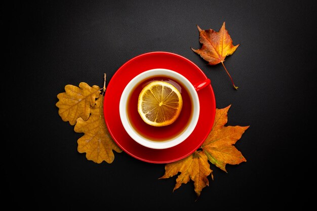 Cup of tea with autumn leaves