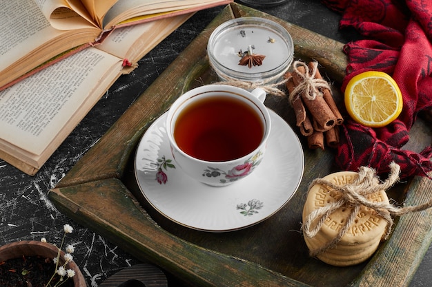 A cup of tea with cookies. 