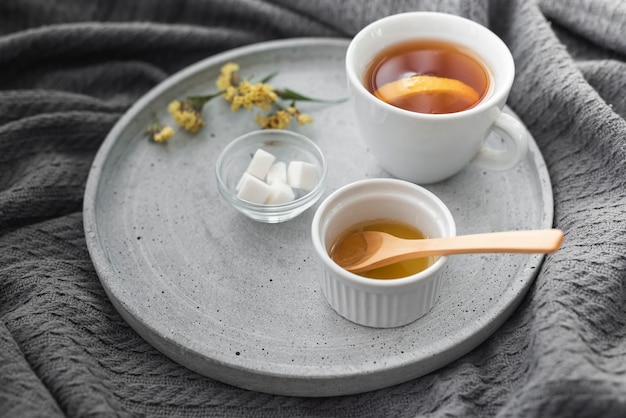 Cup of tea with honey and sugar cubes