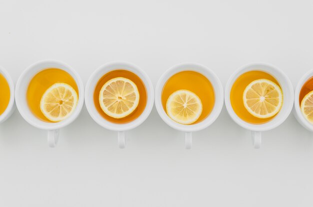 Cup of tea with lemons isolated on white background