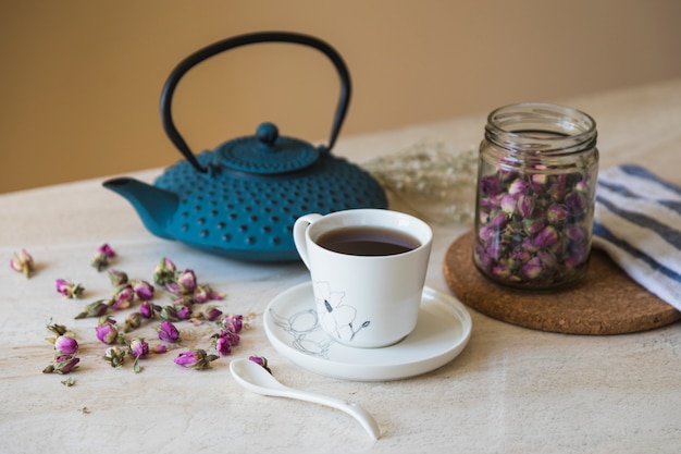 Cup of tea with teapot and breakfast elements