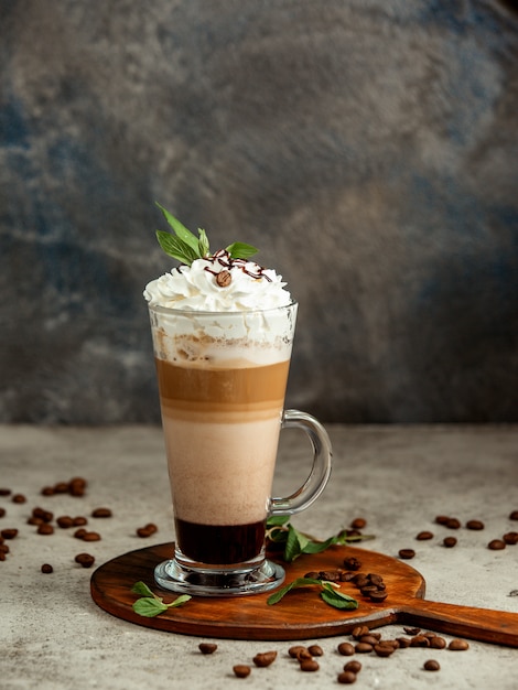 cup of three layered coffee on dark