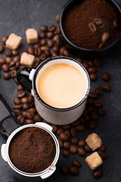 Cup with coffee and coffee beans beside