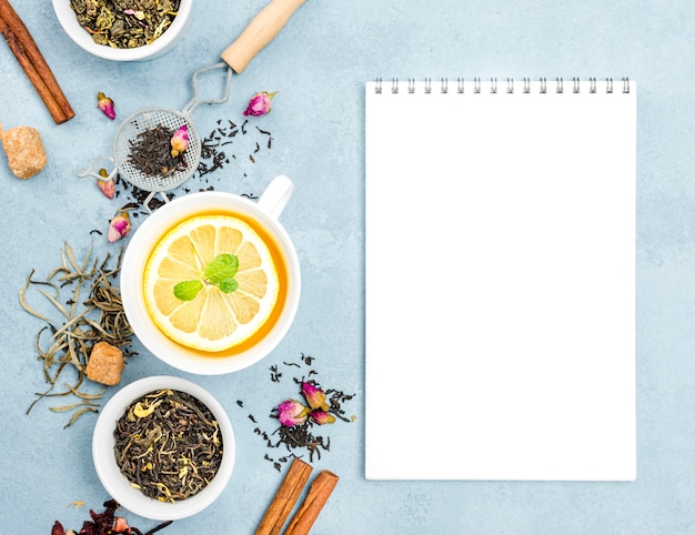 Free photo cup with lemon tea and notebook