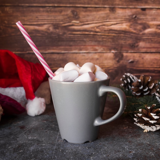 Cup with plastic tube and marshmallows